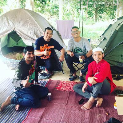 Happy bikers relaxing at their camping ground.
