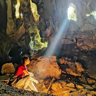 A beam of light illuminating the interior of a cave.