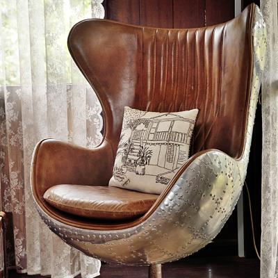 A comfortable leather-bound chair adorn the living room.