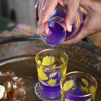 Pouring welcome drinks for guests at Rumah Tiang 16.